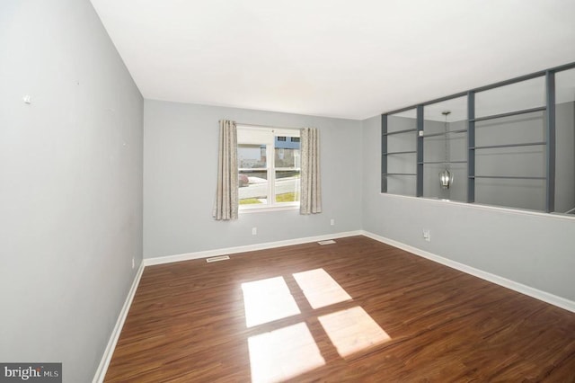 empty room featuring dark hardwood / wood-style flooring