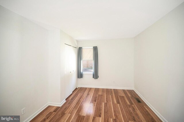 spare room with dark hardwood / wood-style flooring