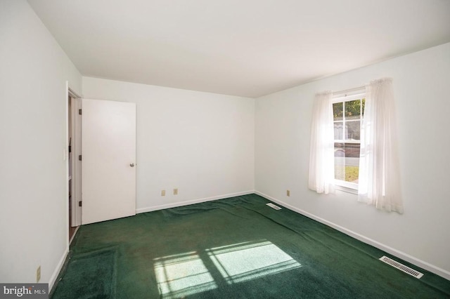 empty room with dark colored carpet