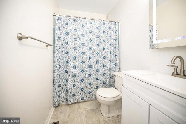 bathroom with vanity, toilet, and curtained shower