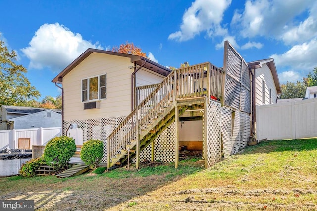 rear view of property featuring a lawn