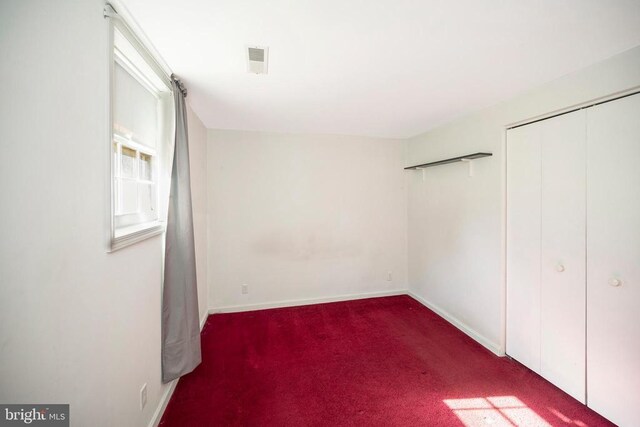 unfurnished bedroom with carpet floors and a closet