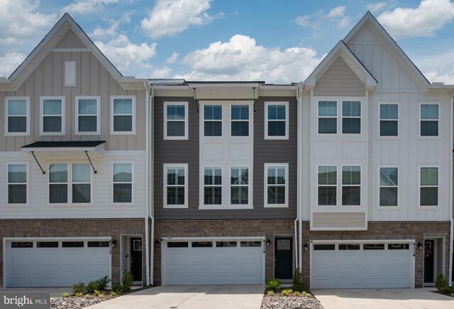 4114 Bolton Ct, Fredericksburg, VA 22408 - townhome / multi-family property with board and batten siding, an attached garage, and driveway