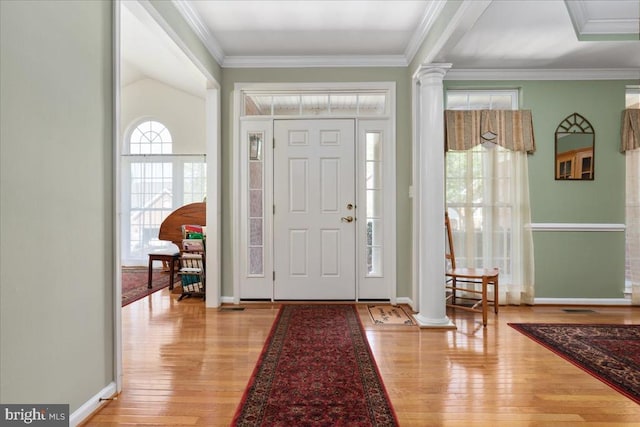  - entrance foyer featuring light wood-style flooring, baseboards, ornate columns, and a healthy amount of sunlight