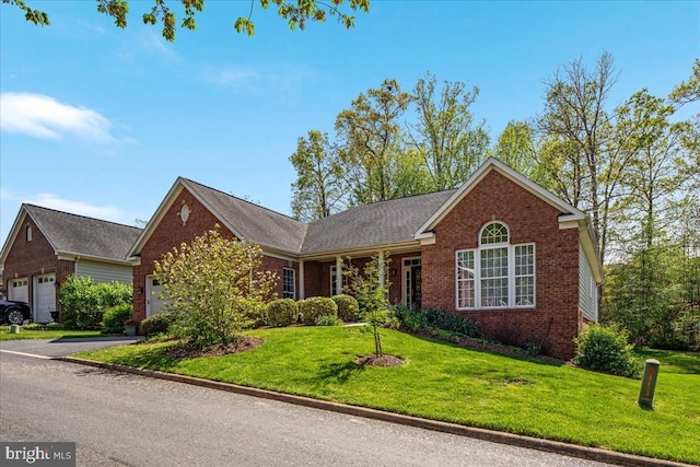  - ranch-style home with a garage, a front lawn, and brick siding