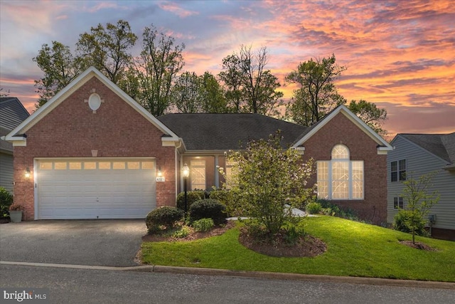 - view of front of property featuring a garage, a front yard, brick siding, and driveway