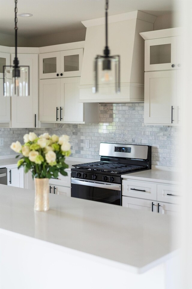 409 Peterson Ln, Waynesboro, VA 22980 - kitchen featuring stainless steel range with gas cooktop, light countertops, hanging light fixtures, and white cabinetry