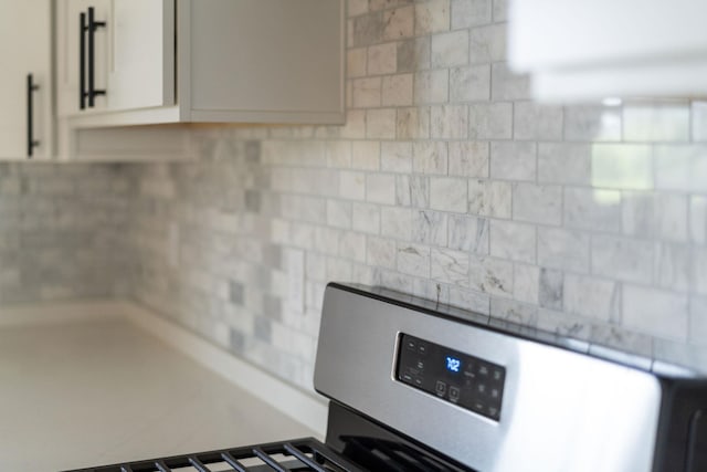 409 Peterson Ln, Waynesboro, VA 22980 - kitchen view of stove, tasteful backsplash, and white cabinets