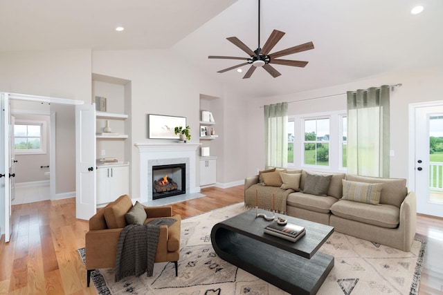 409 Peterson Ln, Waynesboro, VA 22980 - living area with ceiling fan, vaulted ceiling, a fireplace, light wood-style floors, and baseboards