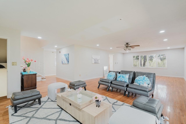 living area with recessed lighting, light wood finished floors, baseboards, a ceiling fan, and stairway