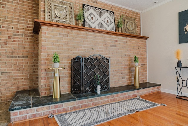 detailed view of wood finished floors, ornamental molding, and baseboards