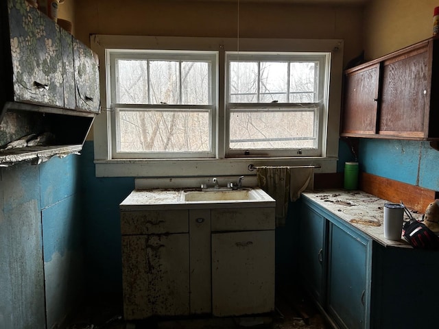 kitchen featuring a sink and light countertops
