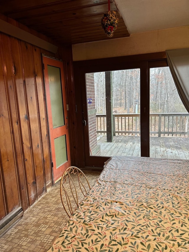 foyer entrance featuring wooden walls and wooden ceiling