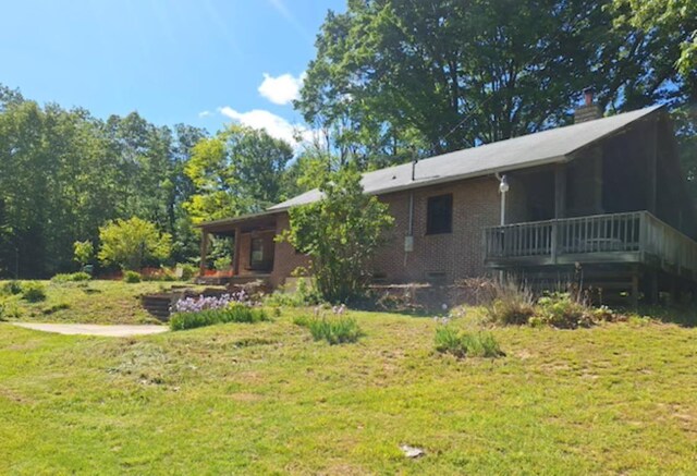 2219 Hewitt Rd, Swoope, VA 24479 - rear view of house featuring a lawn, brick siding, and a wooden deck
