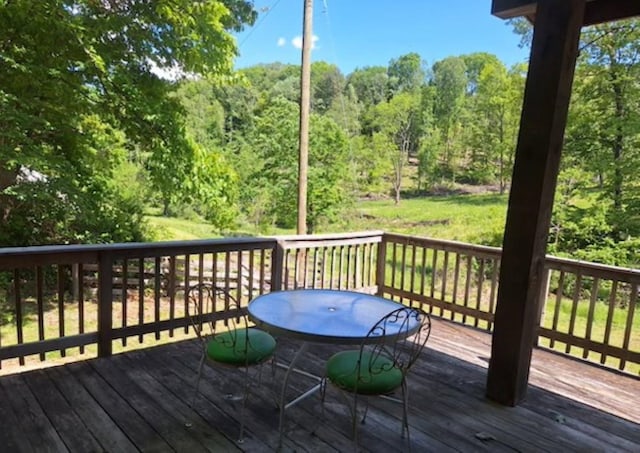 wooden deck featuring a view of trees