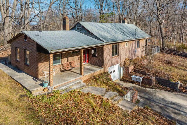 2219 Hewitt Rd, Swoope, VA 24479 - view of front of home featuring a chimney, covered porch, brick siding, and an attached garage