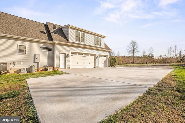 5761 Agecroft Rd, Spotsylvania, VA 22551 - view of home's exterior featuring central AC unit, concrete driveway, an attached garage, and roof with shingles