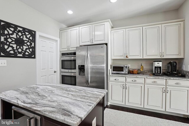 5761 Agecroft Rd, Spotsylvania, VA 22551 - kitchen with stainless steel appliances, light stone countertops, white cabinetry, recessed lighting, and a center island