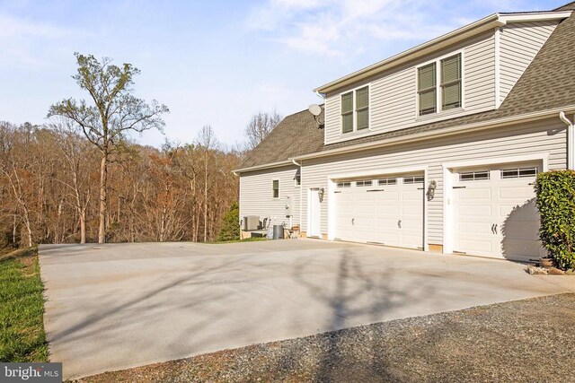 5761 Agecroft Rd, Spotsylvania, VA 22551 - view of home's exterior with driveway, roof with shingles, and an attached garage