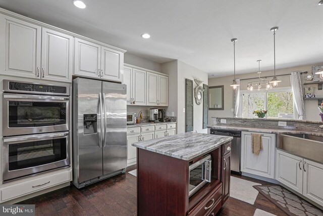 5761 Agecroft Rd, Spotsylvania, VA 22551 - kitchen featuring stainless steel appliances, light stone counters, white cabinetry, dark wood-style flooring, and recessed lighting