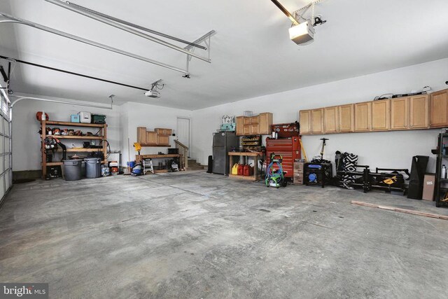 5761 Agecroft Rd, Spotsylvania, VA 22551 - garage with a garage door opener and freestanding refrigerator