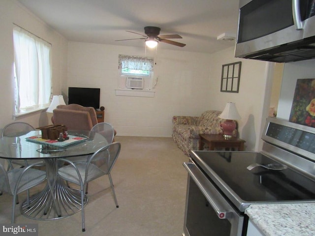 dining room with cooling unit, ceiling fan, and light colored carpet