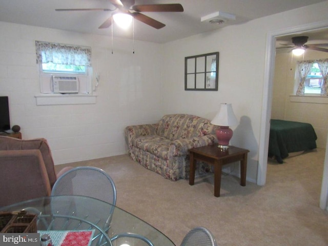 carpeted living room with cooling unit and ceiling fan