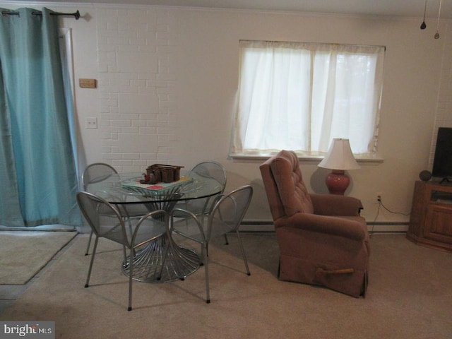 carpeted dining area with ornamental molding and a baseboard heating unit