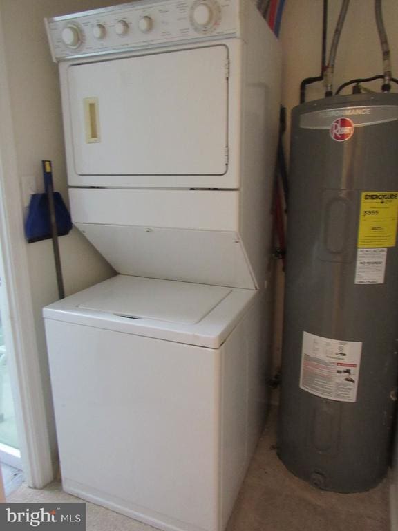 laundry room featuring water heater and stacked washing maching and dryer