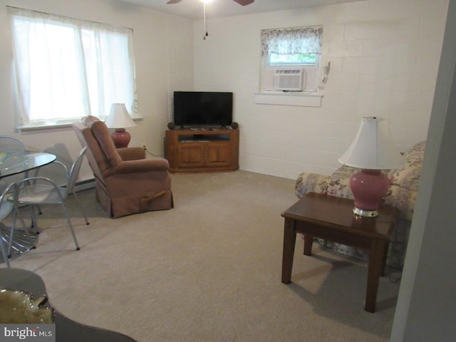 carpeted living room with cooling unit and ceiling fan