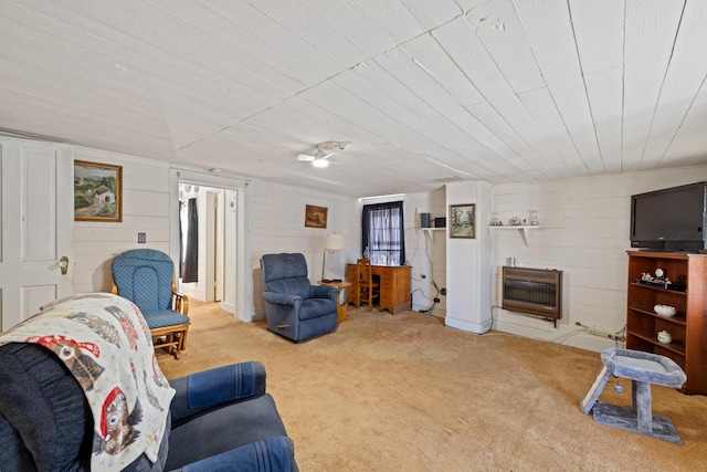 living area featuring heating unit and carpet floors