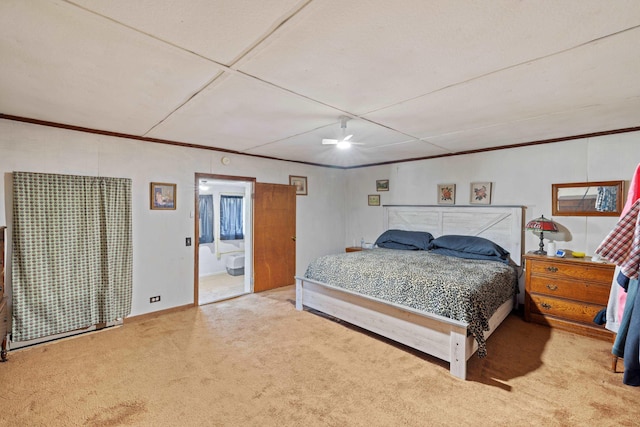 carpeted bedroom featuring ceiling fan and ornamental molding