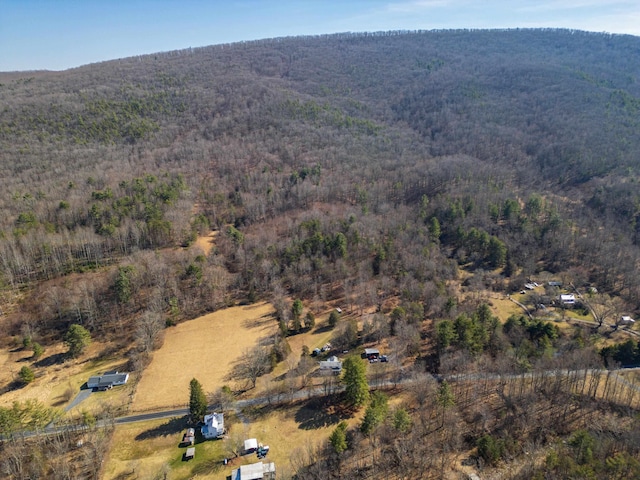 drone / aerial view with a wooded view