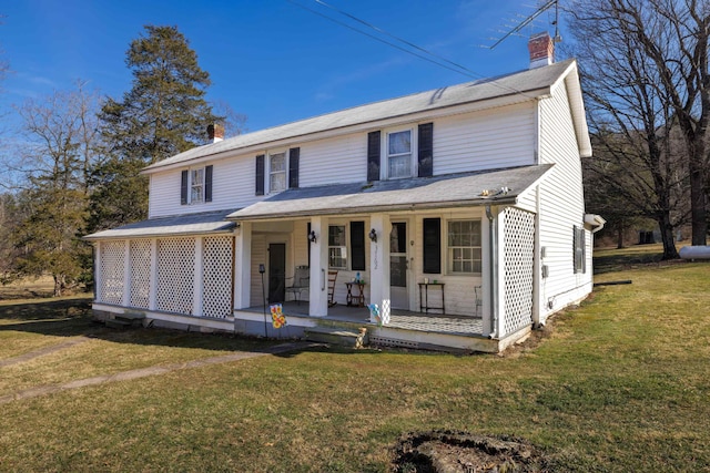 view of front facade with a porch, a chimney, and a front yard