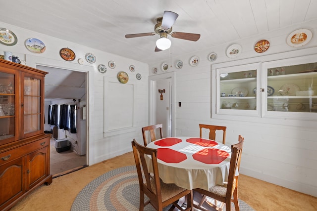 dining area featuring light carpet and ceiling fan