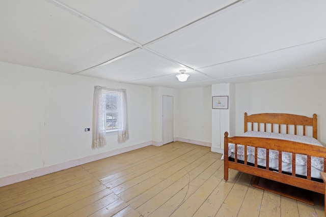 bedroom with baseboards and light wood-style flooring