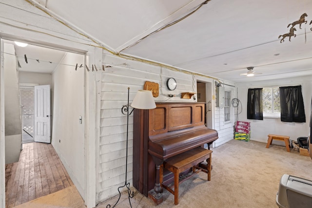 interior space with light colored carpet, a ceiling fan, and vaulted ceiling