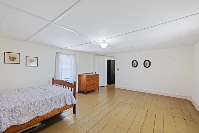 bedroom featuring light wood-type flooring and baseboards