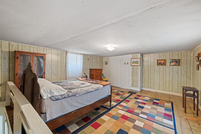 bedroom with light wood finished floors and baseboards