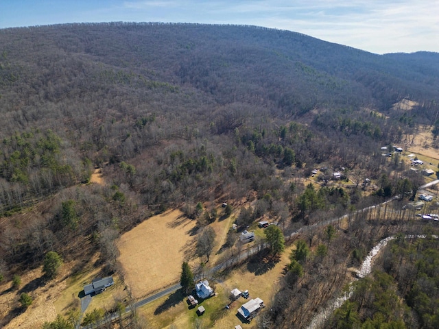 drone / aerial view with a mountain view and a forest view