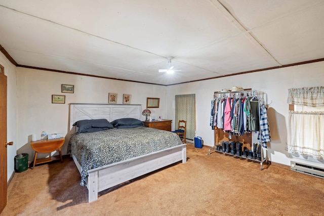 bedroom featuring baseboard heating, crown molding, ceiling fan, and carpet floors