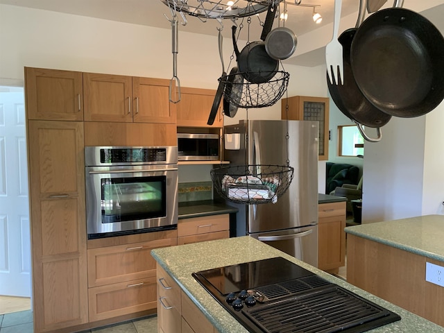 kitchen featuring appliances with stainless steel finishes and light stone countertops