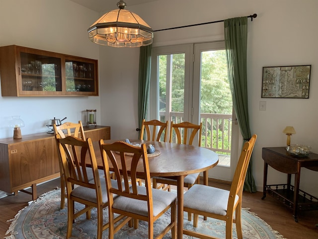 dining area featuring dark hardwood / wood-style flooring, a notable chandelier, and plenty of natural light