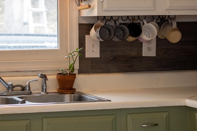 kitchen featuring sink and green cabinets