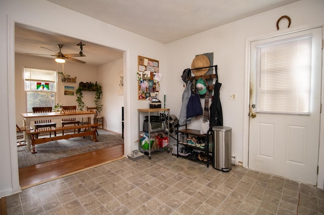 interior space with ceiling fan