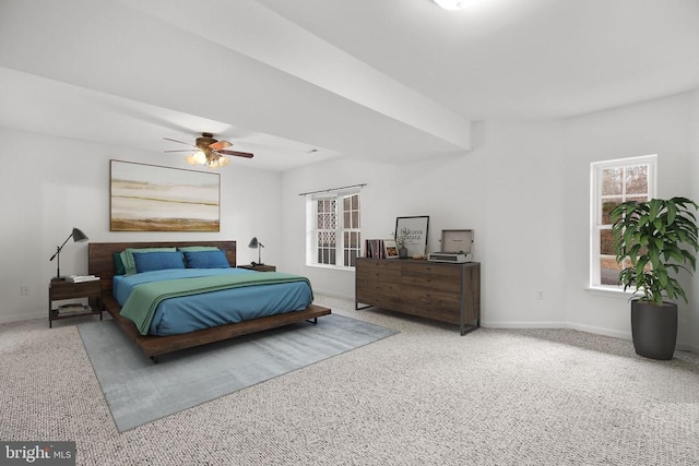 carpeted bedroom with ceiling fan and baseboards