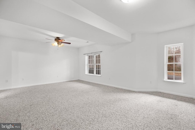 spare room with baseboards and ceiling fan