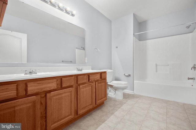 bathroom featuring double vanity, toilet, tub / shower combination, and a sink