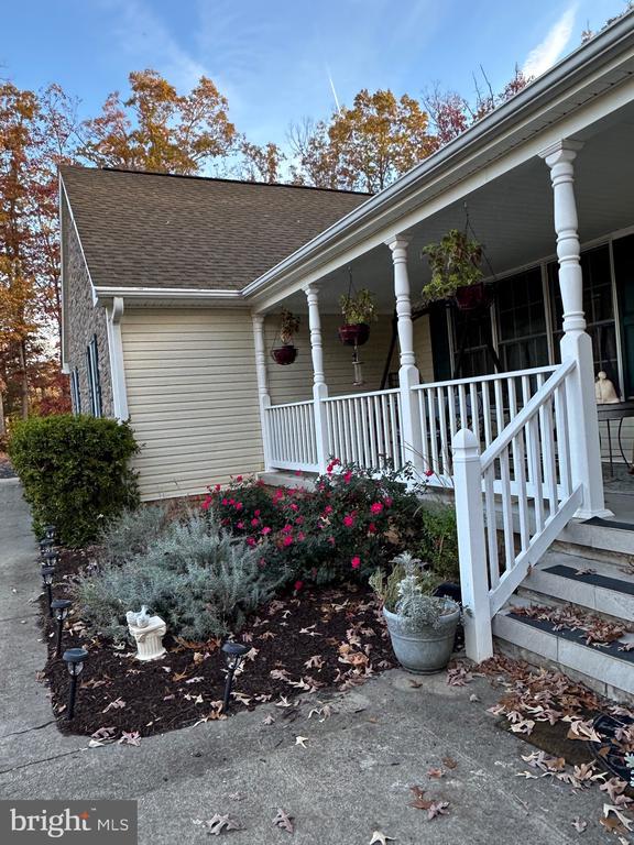view of front of property featuring covered porch and a shingled roof