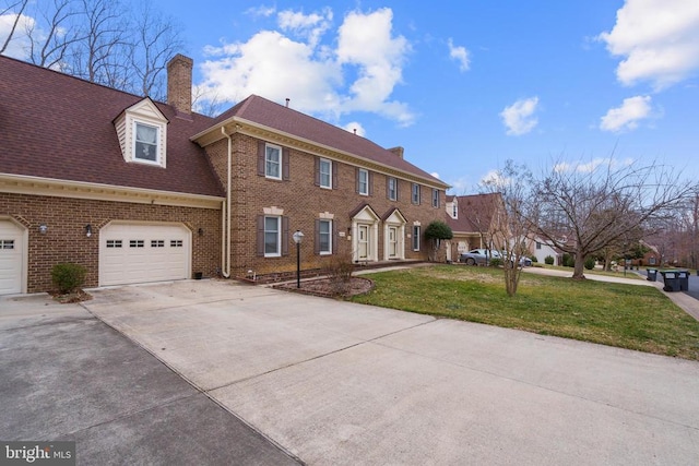 view of front of home with brick siding, a front lawn, concrete driveway, a chimney, and a garage